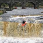 Photo of the Ennistymon Falls in County Clare Ireland. Pictures of Irish whitewater kayaking and canoeing. Tiernan off the ledge. Photo by Tiernan
