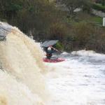 Photo of the Ennistymon Falls in County Clare Ireland. Pictures of Irish whitewater kayaking and canoeing. Connor Upton with a boof. Photo by Tiernan