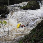 Photo of the Dargle river in County Wicklow Ireland. Pictures of Irish whitewater kayaking and canoeing. rare photo of Rj coffey upside downin hole just after main falls. Photo by steve fahy